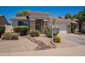 Attractive single-story home featuring desert landscaping and a two-car garage in a friendly neighborhood at 170 E Canary Ct, San Tan Valley, AZ 85143