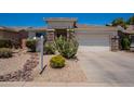 Inviting single-story home with a desert rock garden, native plantings, and a two-car garage at 170 E Canary Ct, San Tan Valley, AZ 85143