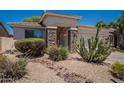 Well-maintained single-story home with desert landscape, stone accents, and a convenient two-car garage at 170 E Canary Ct, San Tan Valley, AZ 85143