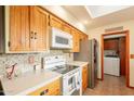 Spacious kitchen featuring quartz countertops, stainless steel appliances, wooden cabinets and a tile backsplash at 1708 E Westchester Dr, Tempe, AZ 85283