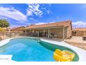 Sparkling pool with a -safe fence and a covered patio, perfect for backyard fun and relaxation at 1744 E Fremont Rd, Phoenix, AZ 85042
