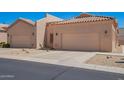 Tan homes featuring two car garages, desert landscaping and tile roofs at 18650 N 91St Ave # 3301, Peoria, AZ 85382