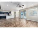 Open-concept living space with wood-look floors, recessed lighting, and access to the outdoor pool area at 18675 W Foothill Dr, Surprise, AZ 85387
