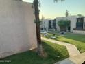 Lush community green space has picnic tables, barbeque grills, mature trees and a gated pool at 1927 E Hampton Ave # 260, Mesa, AZ 85204