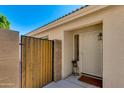 Inviting front entrance with a decorative security door, desert landscaping, and secure courtyard gate at 19851 N 35Th St, Phoenix, AZ 85050