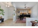 Bright living space with a piano, tile flooring, ceiling fan, and a welcoming ambiance at 19851 N 35Th St, Phoenix, AZ 85050
