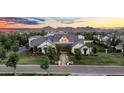 Expansive estate featuring impeccable landscaping, lush lawns, and breathtaking mountain views in the background at 20649 E Vallejo Ct, Queen Creek, AZ 85142