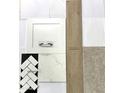 Close up of an interior design sample collection with tile, countertop, wood flooring, white cabinet, and carpet at 22705 E Happy Rd, Queen Creek, AZ 85142