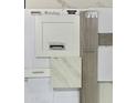 Sample board showing the interior design selections for the home, featuring white cabinets and stone countertops at 23039 E Watford Dr, Queen Creek, AZ 85142