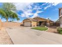 Well-maintained single-story house with a two-car garage and a green lawn at 2341 S Gordon --, Mesa, AZ 85209
