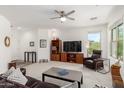 Spacious living room with ceiling fan, plush carpeting, and media center at 2425 W Bronco Butte Trl # 2011, Phoenix, AZ 85085