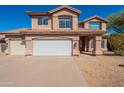 Two-story home featuring a three car garage, neutral stucco exterior, and a well-maintained front yard at 26286 N 45Th Pl, Phoenix, AZ 85050