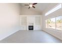 Bright living room featuring a fireplace, built-in shelves, tile flooring, and large windows at 26286 N 45Th Pl, Phoenix, AZ 85050