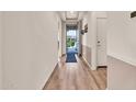 Inviting hallway with wood-look flooring, neutral walls, and a view of the front yard through the front door at 27606 W Tonopah Dr, Buckeye, AZ 85396