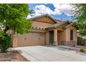 Attractive single-story house featuring a two-car garage, desert landscaping, and a welcoming front entrance at 29751 N 119Th Ln, Peoria, AZ 85383