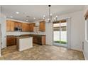 Open kitchen features an island, granite countertops, light wood cabinetry and stainless steel appliances at 318 S Leandro --, Mesa, AZ 85208