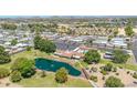Expansive aerial view showing the community with a pond, fountain, pool, mature trees, and well-maintained landscaping at 3433 E Sandra Ter, Phoenix, AZ 85032