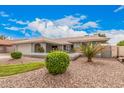 Well-maintained home featuring desert landscaping and vibrant green bushes, offering curb appeal at 3701 E Morrow Dr, Phoenix, AZ 85050