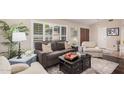 Inviting living room with a comfortable sofa, bright shutters, and elegant decor at 3701 E Morrow Dr, Phoenix, AZ 85050