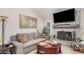 Cozy living room featuring a stone fireplace, a comfortable sofa, and stylish decor at 3701 E Morrow Dr, Phoenix, AZ 85050