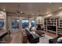 Spacious living room with hardwood floors, a fireplace, built-in shelving and entertainment center at 39241 N Boulder View Dr, Scottsdale, AZ 85262