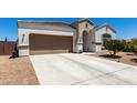 Attractive single-story house with a two-car garage and low-maintenance desert landscaping in a sunny setting at 4080 W Goldmine Mountain Dr, San Tan Valley, AZ 85144