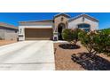 Charming single-story home with a well-maintained yard and covered entryway, plus a two car garage at 4080 W Goldmine Mountain Dr, San Tan Valley, AZ 85144