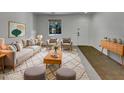 Bright living room with large window, stylish furnishings, and an inviting, cozy ambiance at 43530 W Eddie Way, Maricopa, AZ 85138