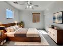 Comfortable main bedroom showcasing neutral tones, modern furniture, and a ceiling fan at 43530 W Eddie Way, Maricopa, AZ 85138