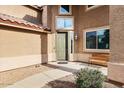 Welcoming front entrance with a cozy bench, covered porch, decorative windows, and attractive landscaping at 462 W Myrtle Dr, Chandler, AZ 85248