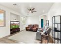 Spacious living room with wood-look floors, ceiling fan, lots of light, and comfortable seating at 462 W Myrtle Dr, Chandler, AZ 85248
