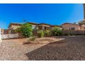 Low-maintenance backyard featuring gravel, plants, and a block fence for privacy at 5808 E Lawndale St, Mesa, AZ 85215