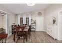 Cozy dining room with wood floors, a rustic table set, and ample natural light at 5808 E Lawndale St, Mesa, AZ 85215