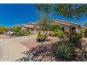 Beautiful single story house featuring low maintenance desert landscaping and a two-car garage at 6031 N Milano Ct, Litchfield Park, AZ 85340