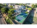 Aerial backyard view of private home featuring a pool, basketball court, built-in barbecue and mature trees at 6286 S Reseda St, Gilbert, AZ 85298