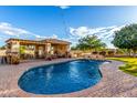 Resort-style pool area with water feature, covered cabana, and lush landscaping at 6286 S Reseda St, Gilbert, AZ 85298