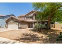 Charming two-story home featuring a desert landscape, a two-car garage and a neutral color palette at 634 W Aviary Way, Gilbert, AZ 85233