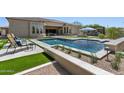 Backyard pool and outdoor lounge area offers a relaxing space for outdoor entertaining at 7032 E Balancing Rock Rd, Scottsdale, AZ 85266