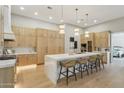 Modern kitchen with a large waterfall island, stainless steel appliances, and custom cabinetry at 7032 E Balancing Rock Rd, Scottsdale, AZ 85266