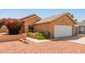 Inviting home exterior with desert landscaping, a two-car garage, and an attractive stucco facade at 7333 N 69Th Ave, Glendale, AZ 85303