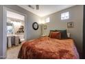 Cozy bedroom featuring neutral paint, terracotta bedding and ensuite bathroom at 7857 N 21St Ave, Phoenix, AZ 85021