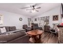 Spacious living room featuring a stone fireplace and plenty of seating with natural light at 8209 E 5Th Ave, Mesa, AZ 85208