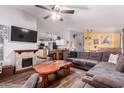 The living room showcases an open floor plan with a stone fireplace, wooden table and dark flooring at 8209 E 5Th Ave, Mesa, AZ 85208
