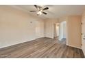 Open living room featuring wood-look floors, neutral walls, and arched doorways at 825 E Michigan Ave, Phoenix, AZ 85022