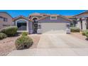 Inviting home exterior with desert landscaping, a two-car garage, and a welcoming entrance at 830 S Cerise --, Mesa, AZ 85208