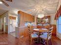 Dining area with hardwood floors, chandelier, and vintage display cabinet at 8600 E Broadway Rd # 88, Mesa, AZ 85208
