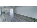 Spacious open-concept living area with gray wood flooring and neutral paint at 907 E Broadmor Dr, Tempe, AZ 85282
