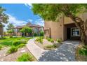 Exterior view showcasing the community's meticulously maintained landscaping and well-lit walkways at 9450 E Becker Ln # 1036, Scottsdale, AZ 85260