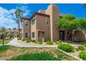 Condominium building with lush landscaping, sidewalk, and mature trees offering a tranquil setting at 9450 E Becker Ln # 1036, Scottsdale, AZ 85260