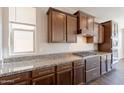 Close-up of a kitchen with granite counters, wood cabinets, and stainless appliances at 98 N Bay Dr, Gilbert, AZ 85233